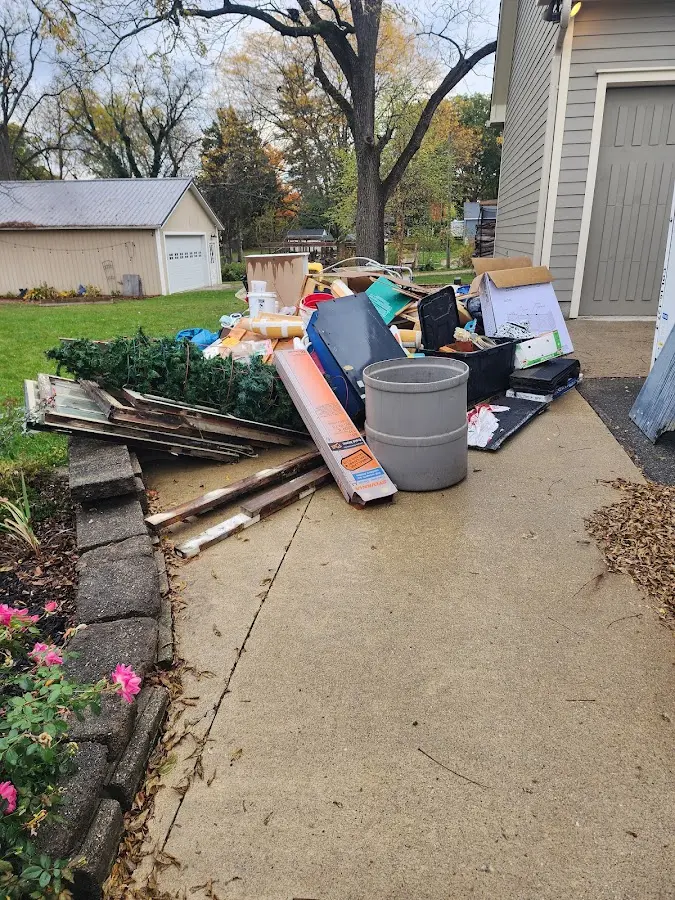 Dumpster being loaded with debris for Estate Cleanout Dumpster Rental in South Lebanon